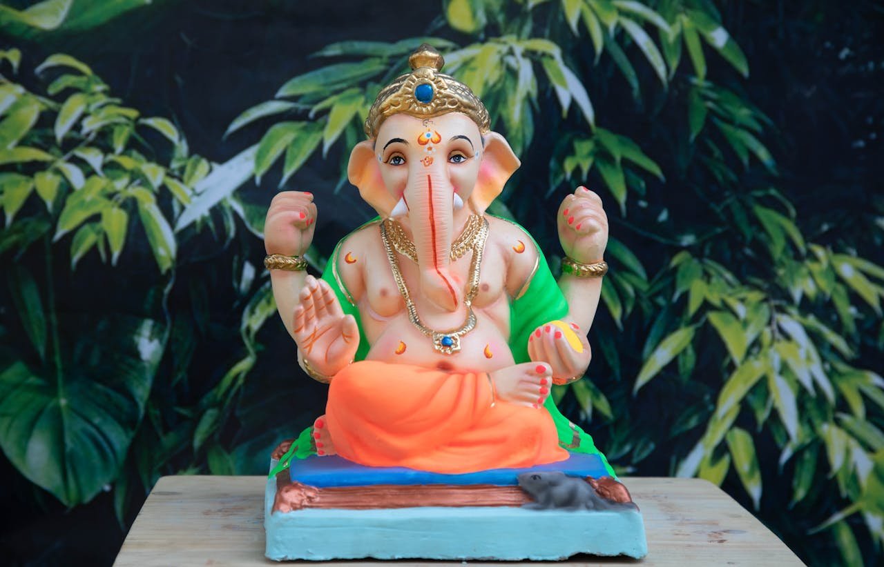 Elephant Headed Deity Figurine on Brown Wooden Table Top